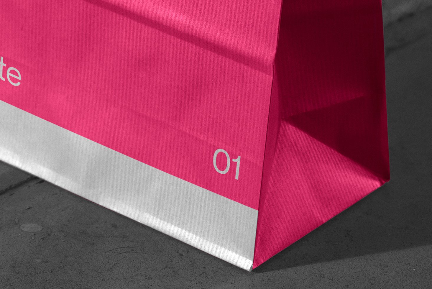 Pink shopping bag mockup on a grayscale background highlighting product packaging design with visible texture and shadow for designers.